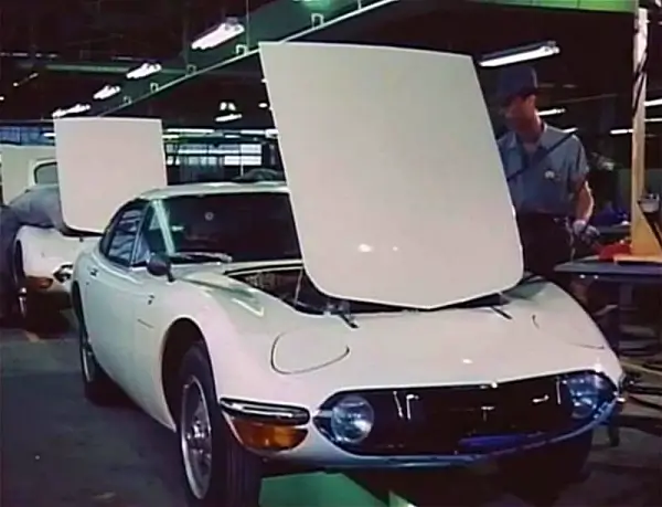 White Toyota 2000GT's on the production line with the bonnet lifted - Toyota 2000GT Tyres